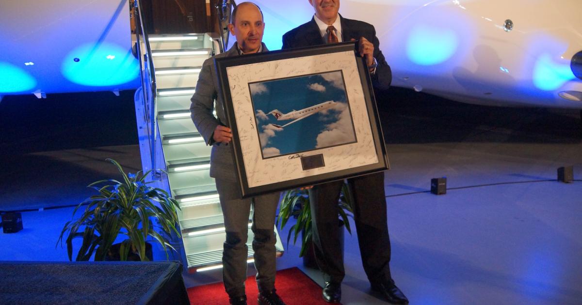 Qatar Airways Group CEO Akbar Al Baker (left) takes delivery of the company's first G650ER from Gulfstream president Mark Burns. Immediately following, the jet flew nonstop from Savannah, Ga., to Doha, Qatar. Photo: Matt Thurber