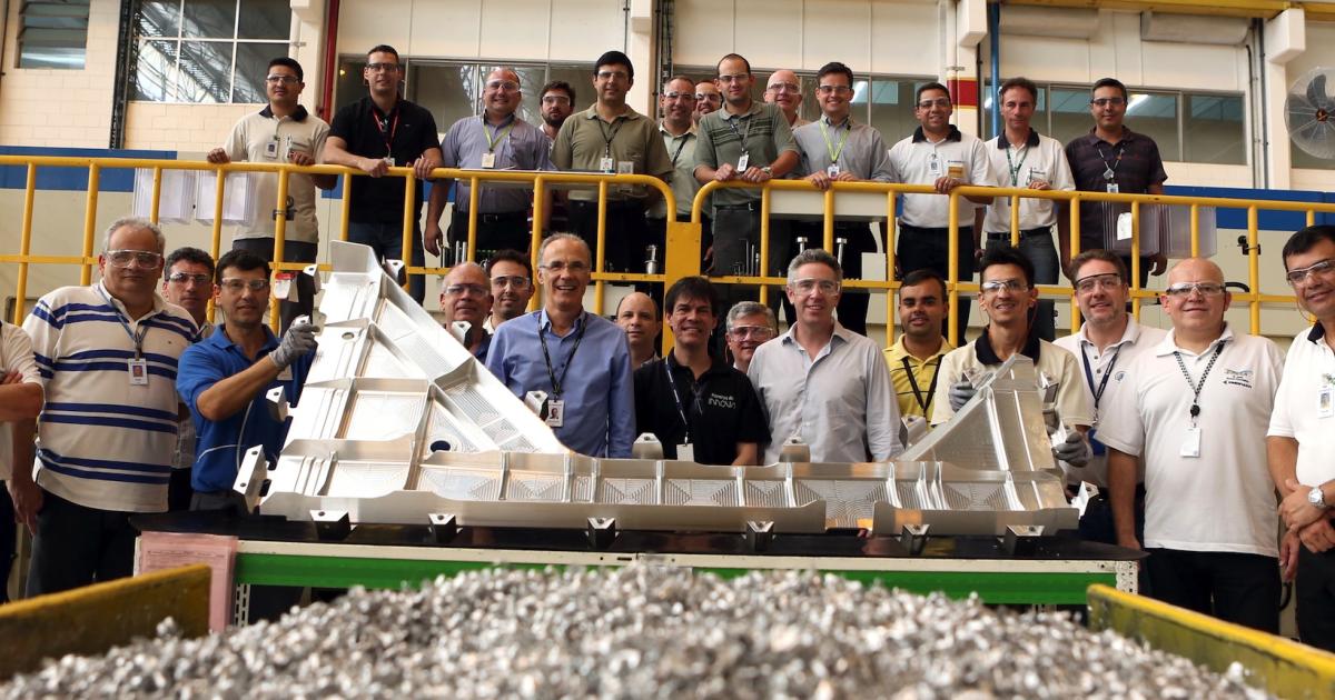 Embraer managers and employees celebrate the fabrication of the first metal part for the E195-E2. (Photo: Embraer)
