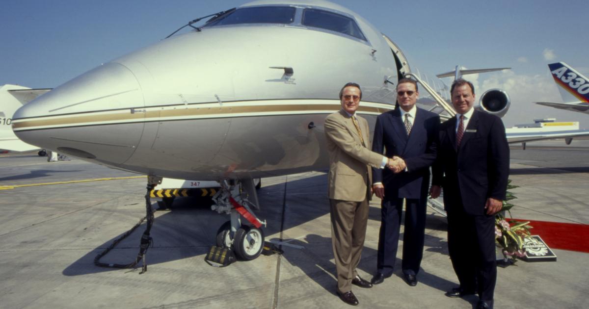 TAG Group CEO Mansour Ojjeh (left), who founded the company with his brother Aziz (center), celebrates another TAG Aeronautics order for Global Express aircraft at the 1997 Dubai Air Show with then Bombardier Business Aircraft president Michael Graff. [Photo: AIN]