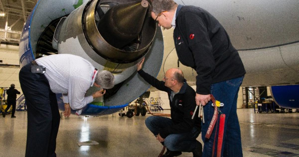 Swiss International crews inspect a CSeries engine in Mirabel, Quebec. (Photo: Bombardier)