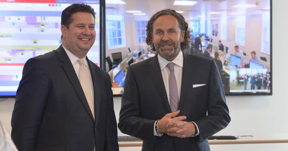 Malta Minister of Tourism and Aviation Edward Zammit Lewis (left) and VistaJet founder and chairman Thomas Flohr tour the company's operations control center in Malta after Flohr announced that VistaJet is moving its global headquarters there. (Photo: VistaJet)