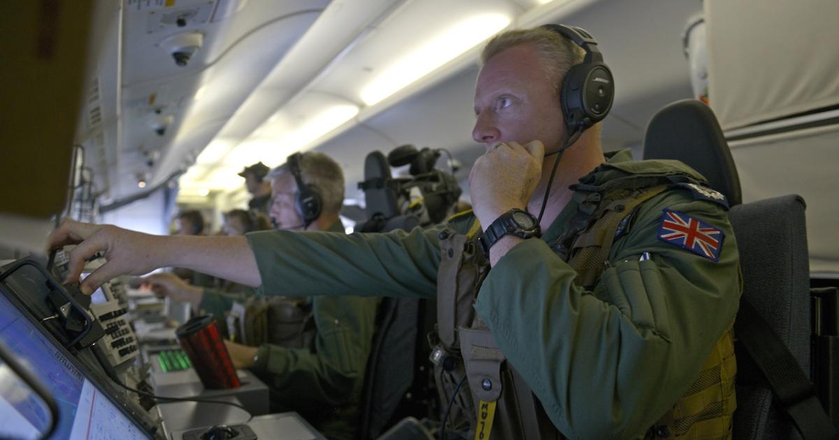 A British Royal Air Force crewman mans a radar station aboard a Boeing P-8A Poseidon in this photo from 2014. (Photo: U.S. Navy)