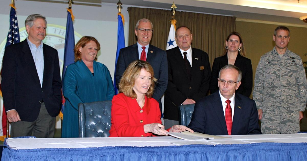 Flanked by North Dakota state and federal officials, Air Force undersecretary Lisa Disbrow signs joint-use accord. (Courtesy: Grand Sky)