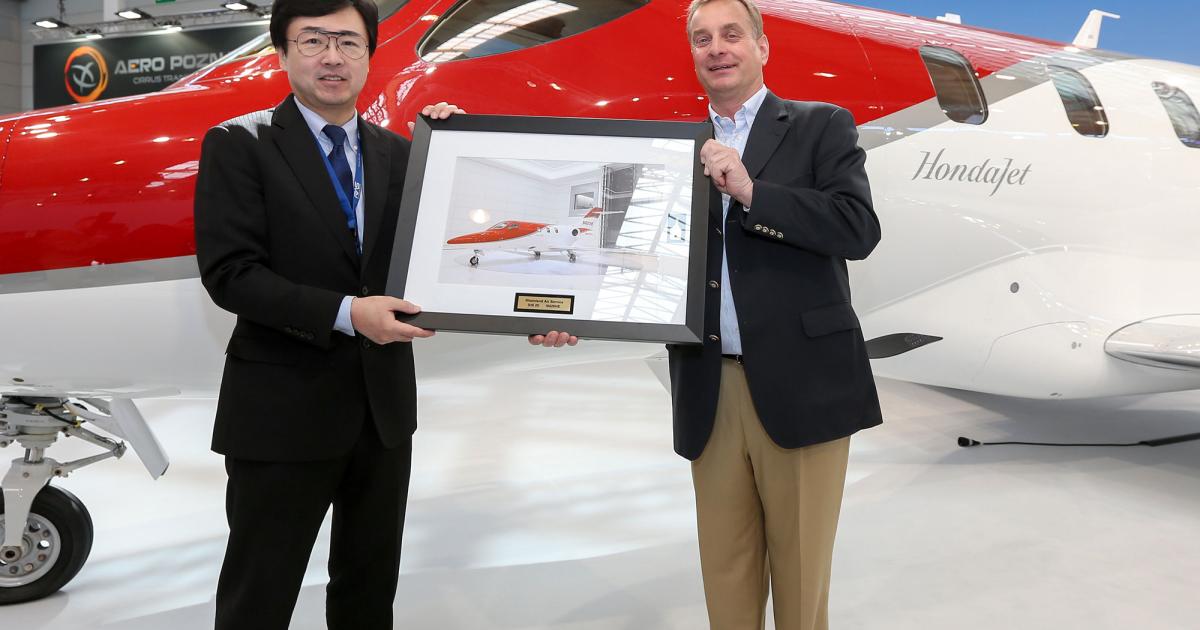 Honda Aircraft president and CEO Michimasa Fujino (left) hands over the first HondaJet for a European customer to Rheinland Air Service chairman and CEO Johannes Graf von Schaesberg at the Aero Friedrichshafen show in Germany. (Photo: Honda Aircraft/Business Wire)