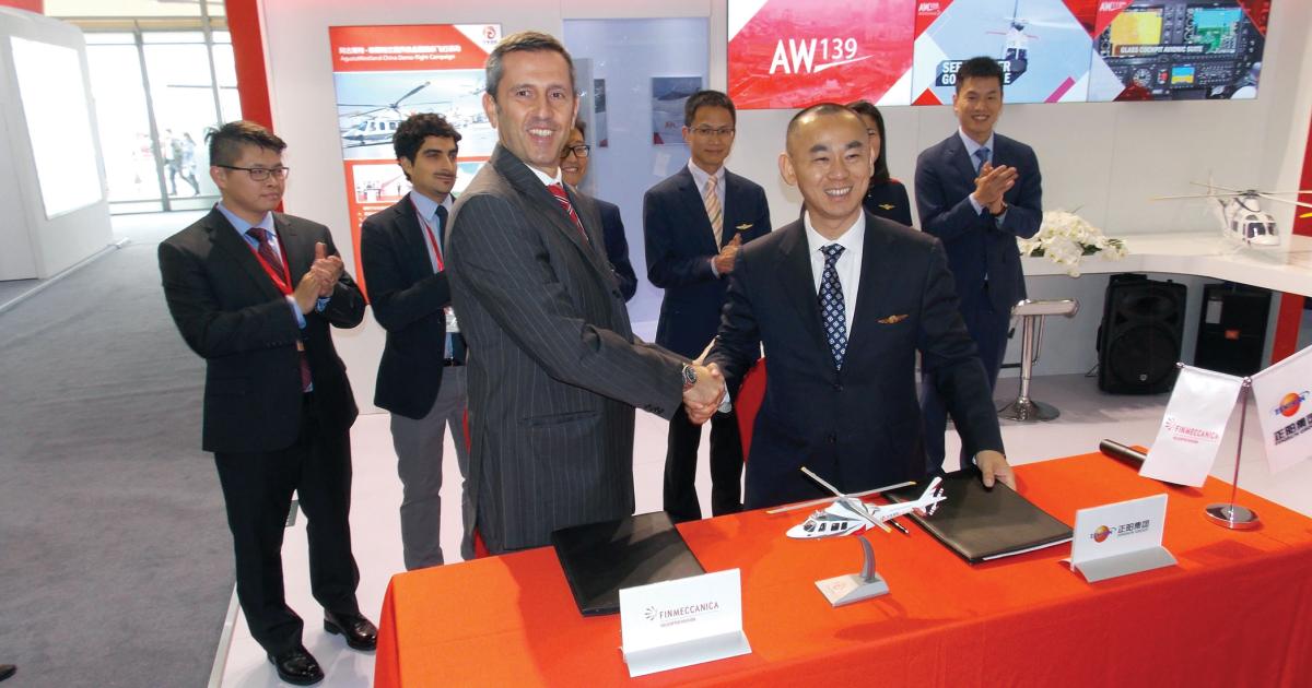Stefano Zalonis, v-p of Finmeccanica Helicopter’s China commercial and international governmental business unit congratulates Jianmin Zou, chairman and CEO of Sino-US and KingWing parent company Zenisun Group on the purchase of 25 EMS-configured AW119Kx single engine helicopters.
