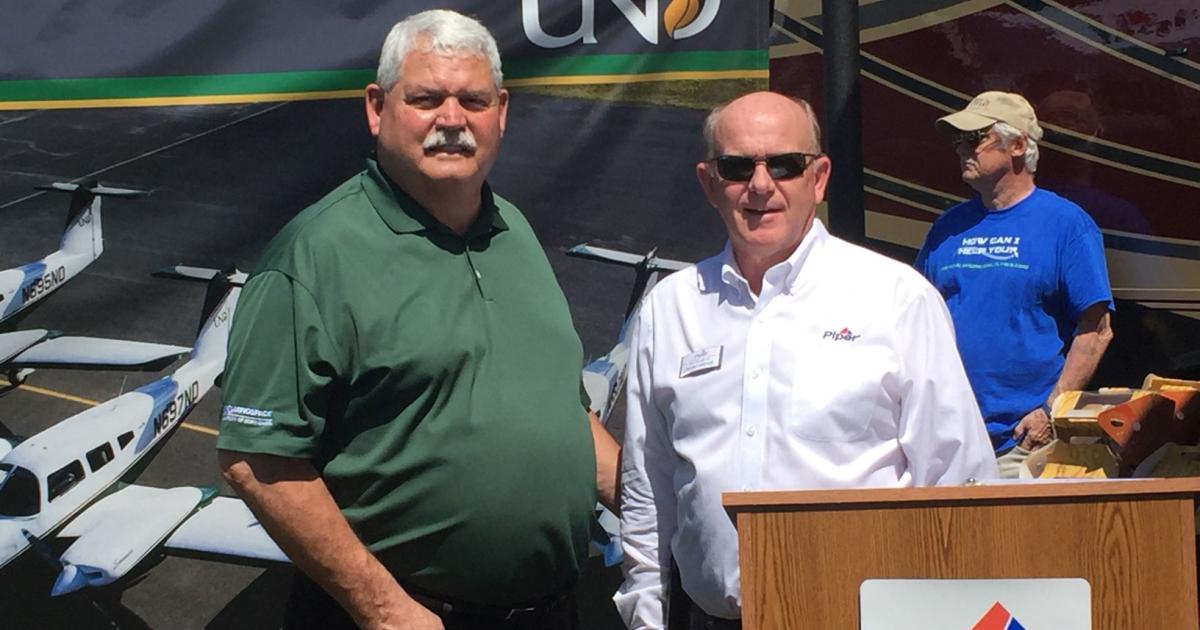 Dr. Bruce Smith, Dean of UND's Jon D. Odegard School of Aerospace Sciences, left, and Piper president and CEO Simon Caldecott were on hand at SNF to announce the school's fleet order for 112 aircraft.