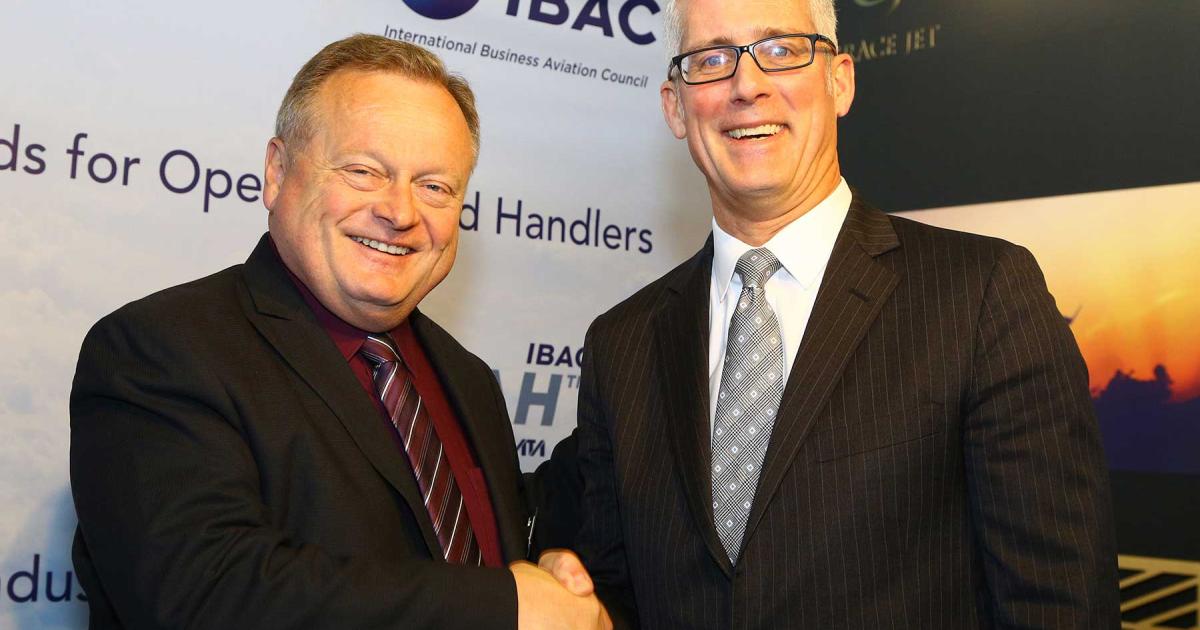 Leo Knaapen, Bombardier's chief of industry affairs (left), and IBAC director general Kurt Edwards shake hands acknowledging the airframer's position as the business association's first industry `Partner' Member.