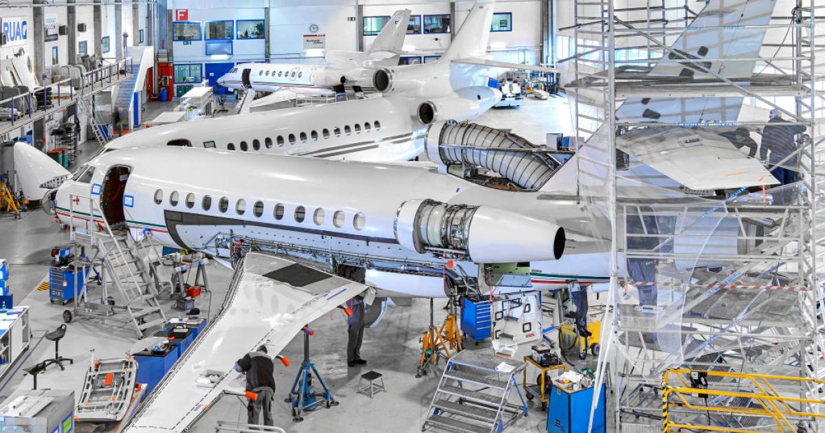 Ruag Aviation's hangar is buzzing, as the Geneva company wraps up two simultaneous C-check inspections on Falcons: a 2000 Classic and a 900B. Photo provided by Ruag shows a 900 (foreground), a 7X (center) and a 50. 