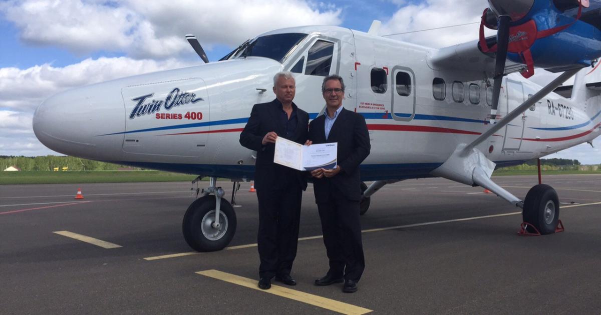 Alexander Mamaev, general director of AeroGeo (left), and Dominique Spragg, Viking vice president of strategic planning, pictured with FESC certificate in front of Viking Twin Otter 400 MSN 925 in Yaroslav, Russia.