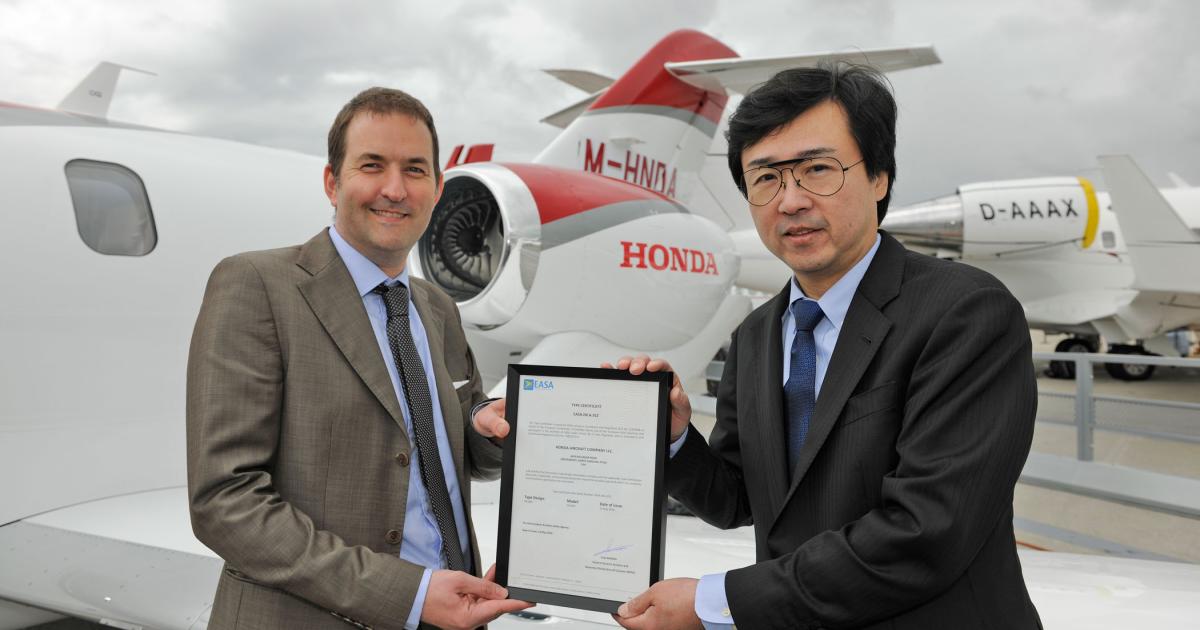 Steven Higgins, EASA’s section manager for high-performance aircraft and turboprops, presents the type certificate for the HondaJet to Honda Aircraft president and CEO Michimasa Fujino. (Photo: Mark Wagner)