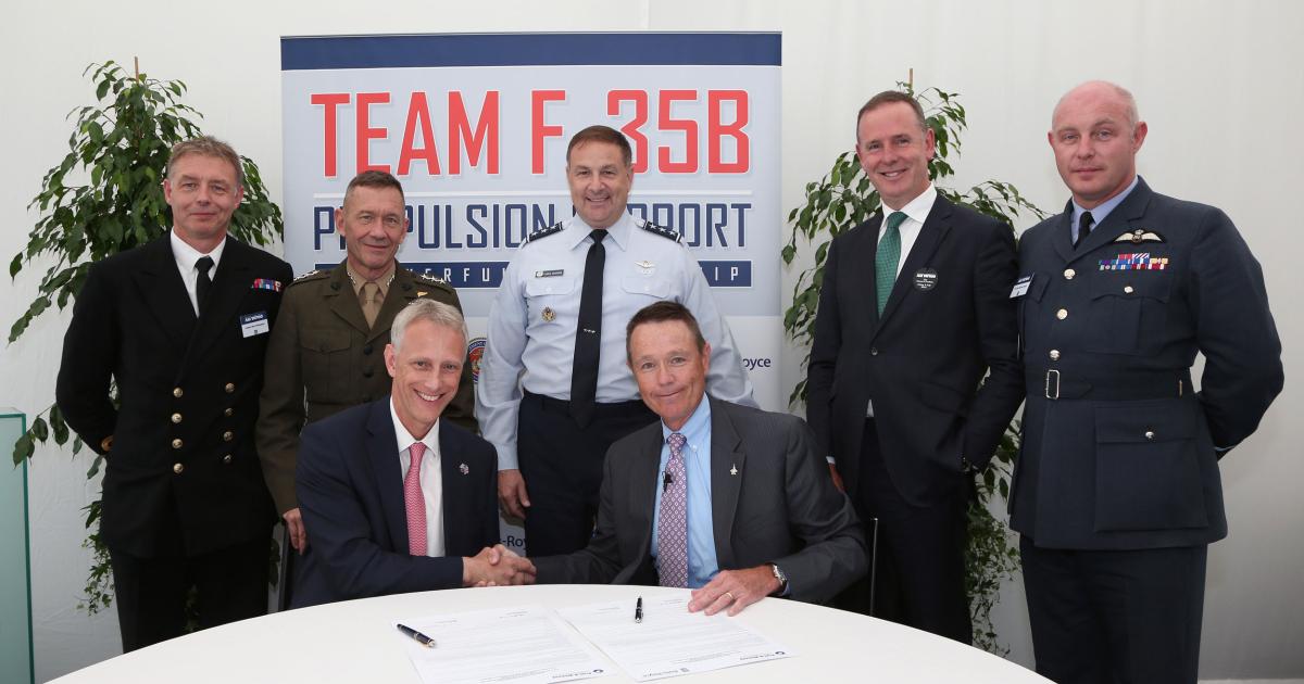 Chris Cholerton (seated, left), president of Rolls-Royce Defence Aerospace signed an MoU here at the show with Bennett Croswell (seated, right), president of Pratt & Whitney military engines. Witnessing the signing were (standing, left to right) Cdr. Rick Thompson, head of the Lightning II team at the UK’s Defence Equipment and Support (DES) organization; Lt. Gen. Jon Davis, deputy commandant for aviation at the U.S. Marine Corps; Lt. Gen. Chris Bogdan, program executive officer for the F-35 in the Joint Program Office; Tony Douglas, chief executive officer of the DES; and Air Cdre Harvey Smyth, Lightning Force Commander for the Royal Air Force.