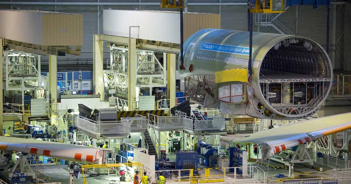 Mechanics prepare to join the first A330neo's center fuselage to its wings in Toulouse. (Photo: Airbus)