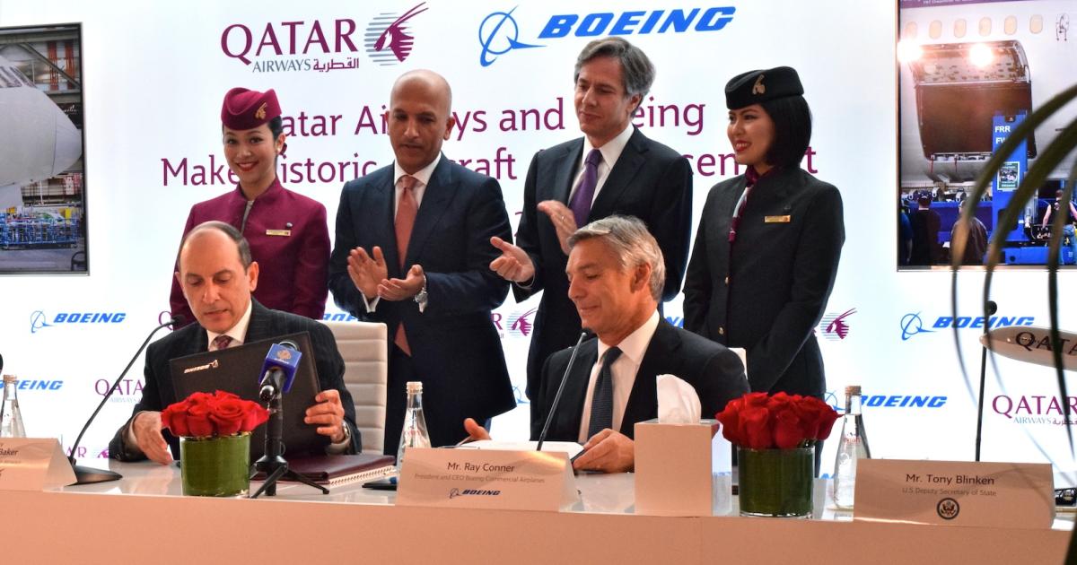 Qatar Airways chief executive Akbar Al Baker and Boeing Commercial Airplanes CEO Ray Conner sign agreement. (Photo: Bill Carey)
