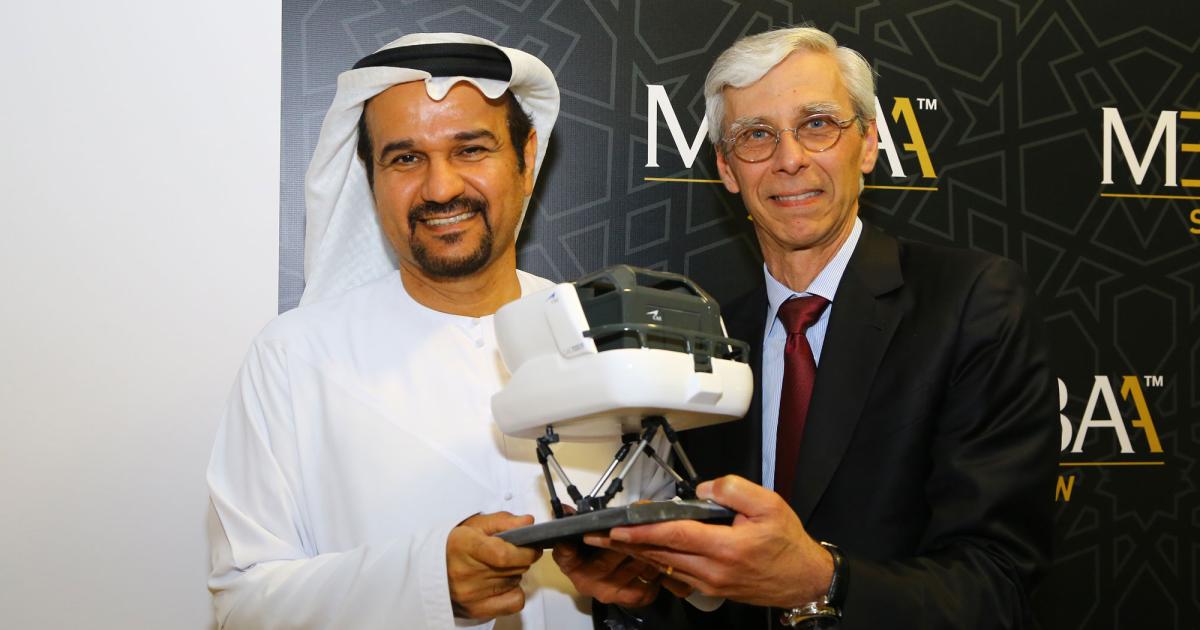 Abu Dhabi Aviation chairman H.E. Nadir  Al Hammadi (left) and Nick Leontidis, CAE group president, civil aviation training solutions, celebrate their two companies’ new agreement.