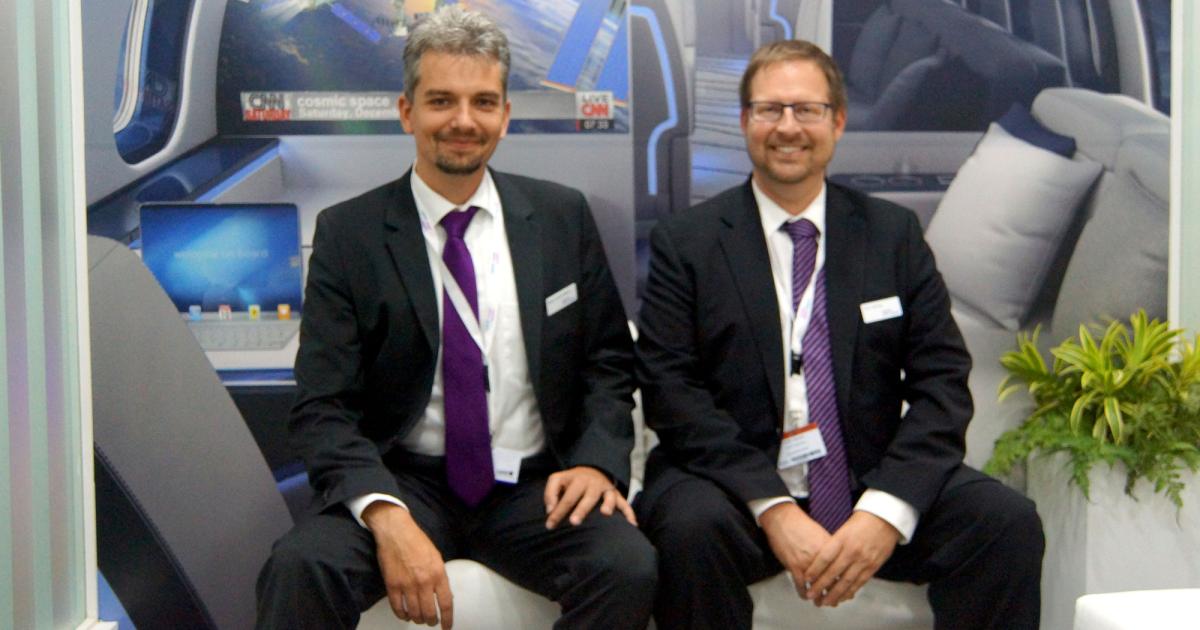 Mark-André Mann, Ruag’s head of sales, business jets, (left), and Jörn Gehrig, sales manager Embraer business jets, pause while discussing interior designs.
