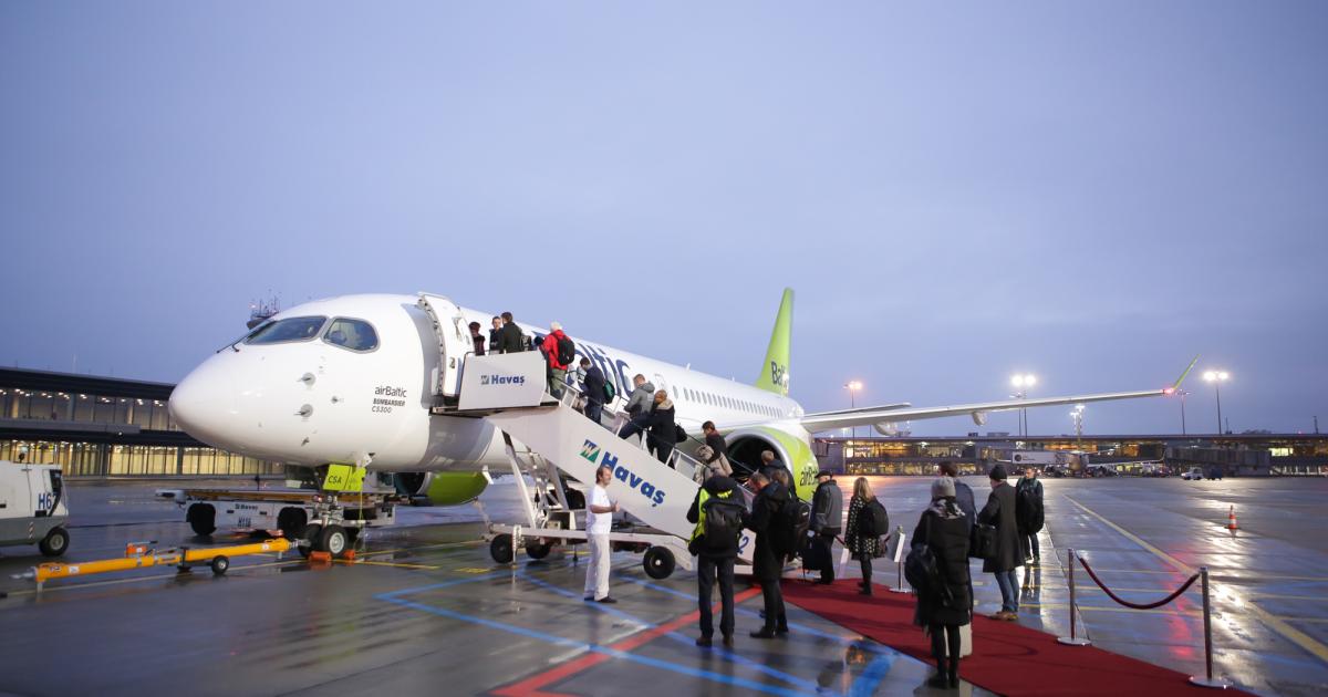 Passengers board Air Baltic's first CS300 for its maiden revenue flight from Riga to Amsterdam. (Photo: Bombardier)