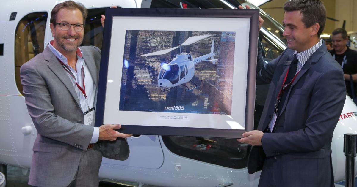 Chandler, Arizona-based Pylon Aviation owner Scott Urschel (left) took delivery of the first Bell 505 Jet Ranger X from Bell  executive vice president of global sales and marketing Patrick Moulay on the opening day of Heli-Expo 2017. (Photo: Bell Helicopter)