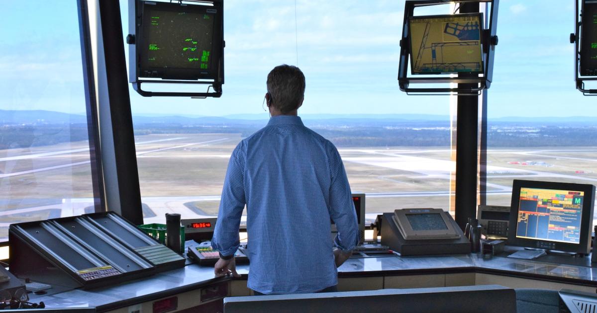 An FAA air traffic controller scans surface from the tower at Dulles International Airport outside of Washington, D.C. (Photo: Bill Carey)