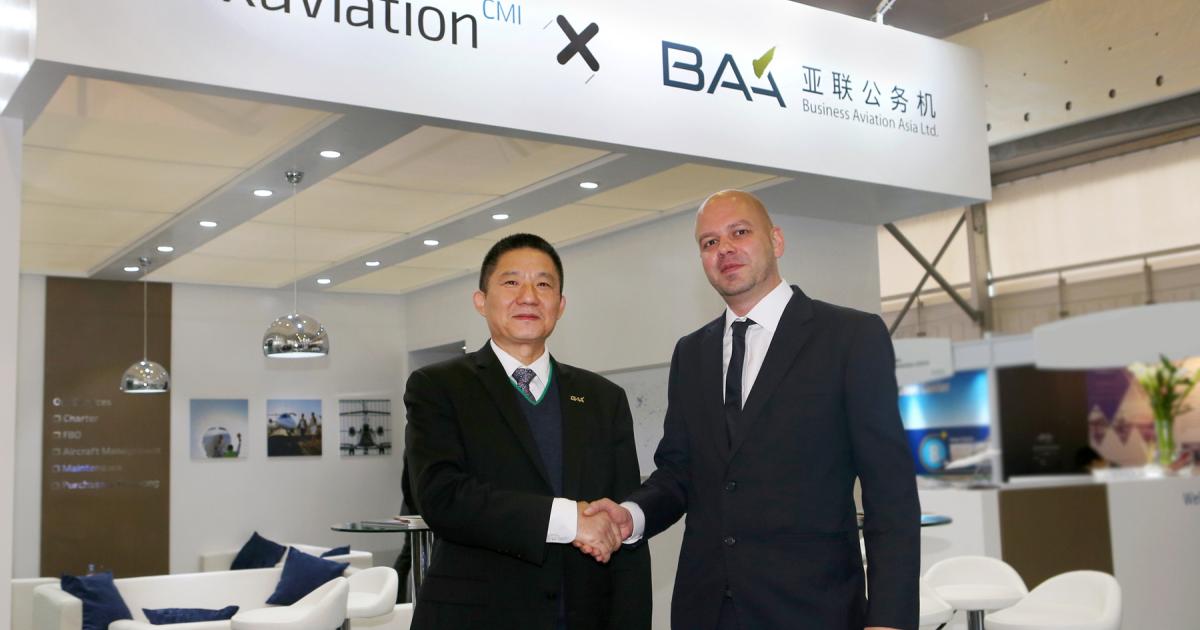 CMIG Aviation president Zhu Yimin (left) and Luxaviation Asia managing director Tom Kunsch shake hands on the partnership between their two companies at the ABACE show in Shanghai.