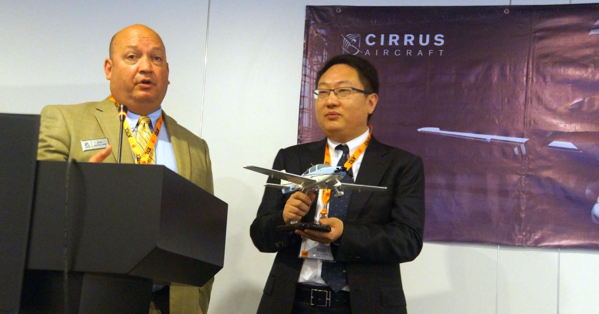 Cirrus’s John Duplaise (left) presented an SR22 model to John Fang of China’s Juhe Aviation, which recently accepted two personalized SR22Xi models.