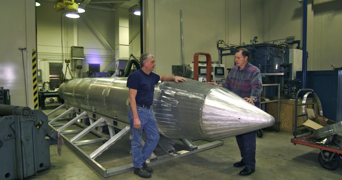 Technicians stand next to a GBU-43/B Massive Ordnance Air Blast bomb in this U.S. Air Force archive photo.