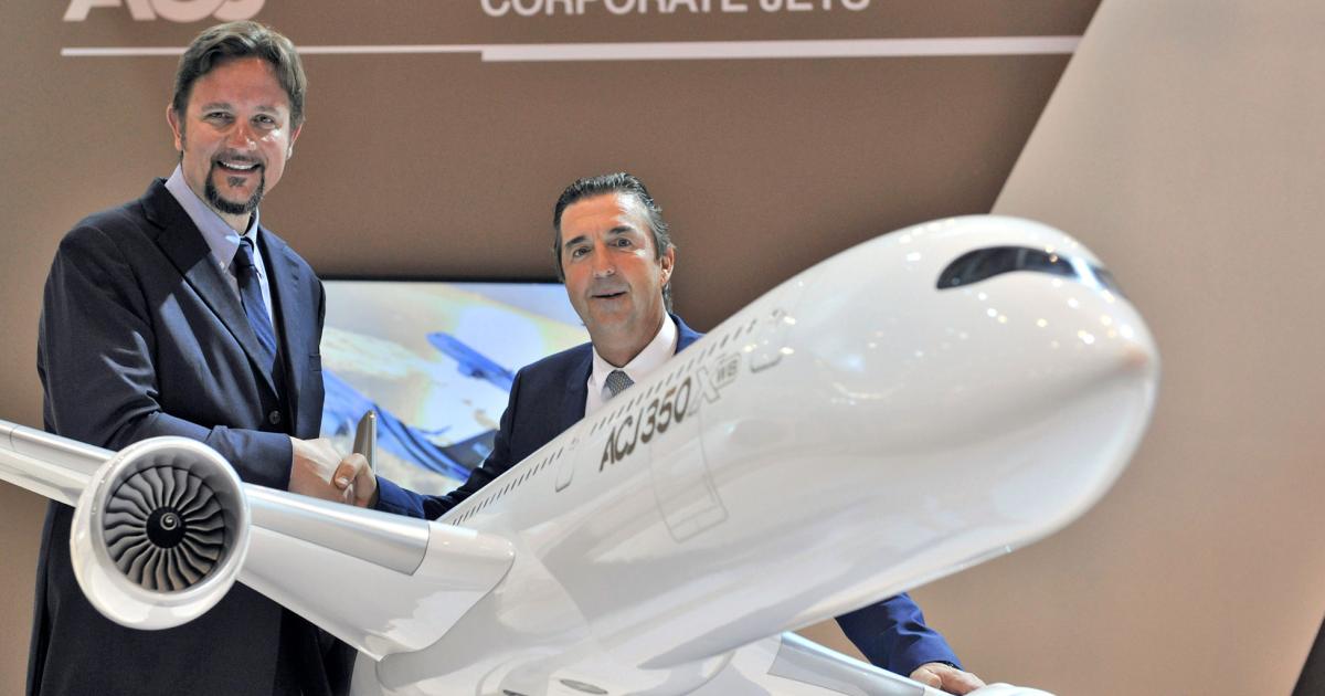 Pascal Jallier, v-p of VIP programs at Sabena Technics, left, and Benoit Defforge, president of Airbus Corporate Jets, shake hands after their two companies agreed on a new pact involving MRO and other services for the airframer’s executive products.
