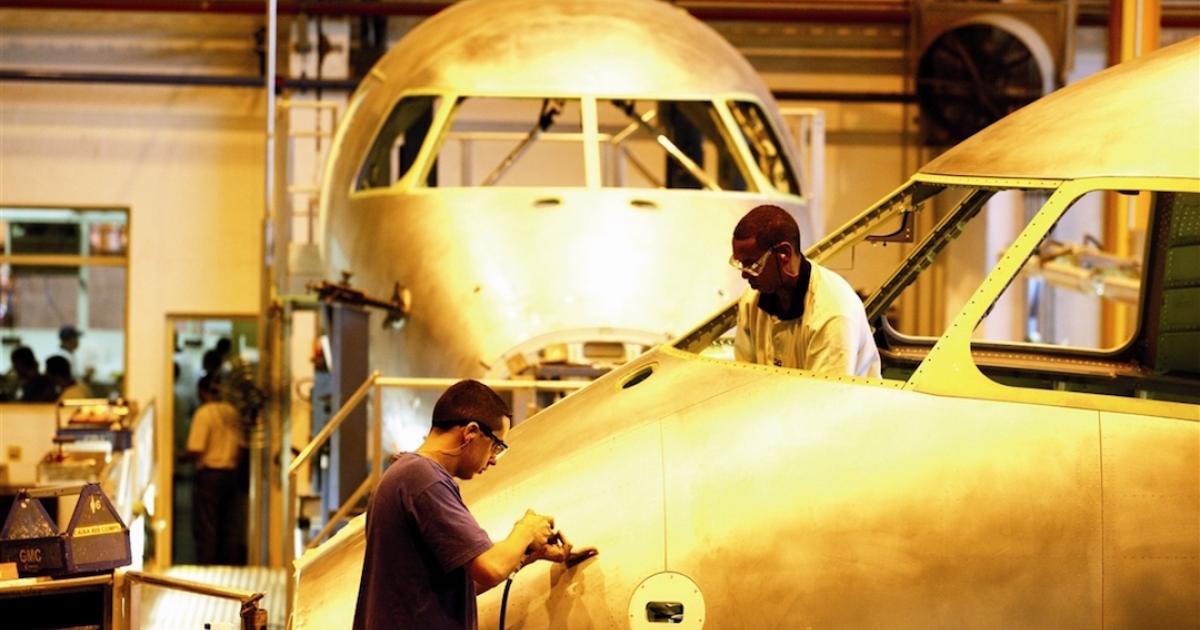 Mechanics at Embraer's main plant in Sao Jose dos Campos, Brazil, work on a current generation E-Jet. (Photo: Embraer)