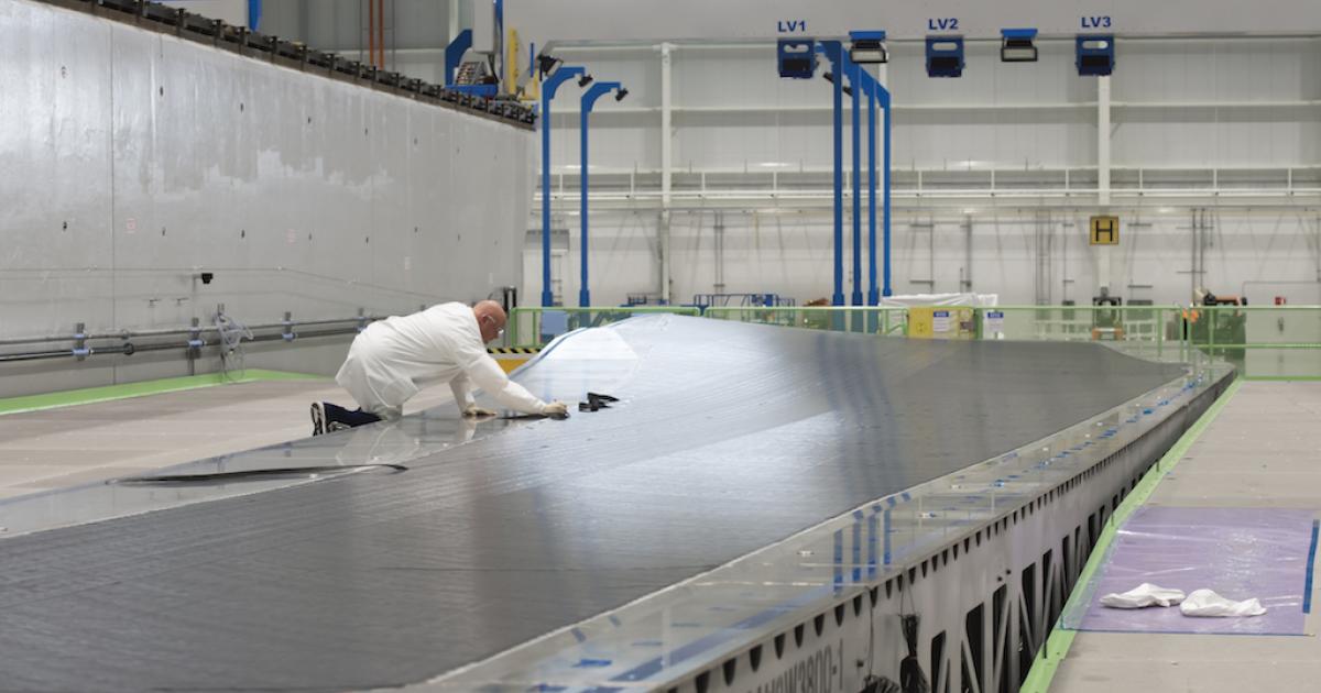 A Boeing engineer tests a prototype panel for a 777X wing at the company's Composite Wing Center (CWC) in Everett, Washington. (Photo: Boeing)