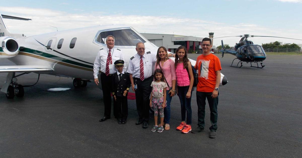Learjet 24F owner Jim Hefelfinger (L.) with recovering cancer patient and pilot-to-be Manuel Acosta, Northeastern Aviation executive vice president and pilot Anthony Russo, and Acosta's family, in front of Hefelfinger's recently refurbished and hush-kitted 1976 Learjet, before taking them on a Make-A-Wish sightseeing flight around New York City. After the visit to Long Island's Republic Airport, the Dallas residents were flown back to Manhattan on the Hover-Views Airbus Helicopters AS355 TwinStar in the background.