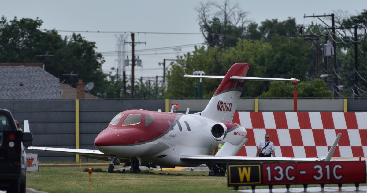 After dodging thunderstorms on the flight from Philadelphia International Airport, the pilot of this HondaJet was unable to stop the aircraft on the asphalt surface of Midway’s 6,500-foot-long Runway 31C, which was wet at the time of the incident. (Photo: Rob Olewinski/AIN)