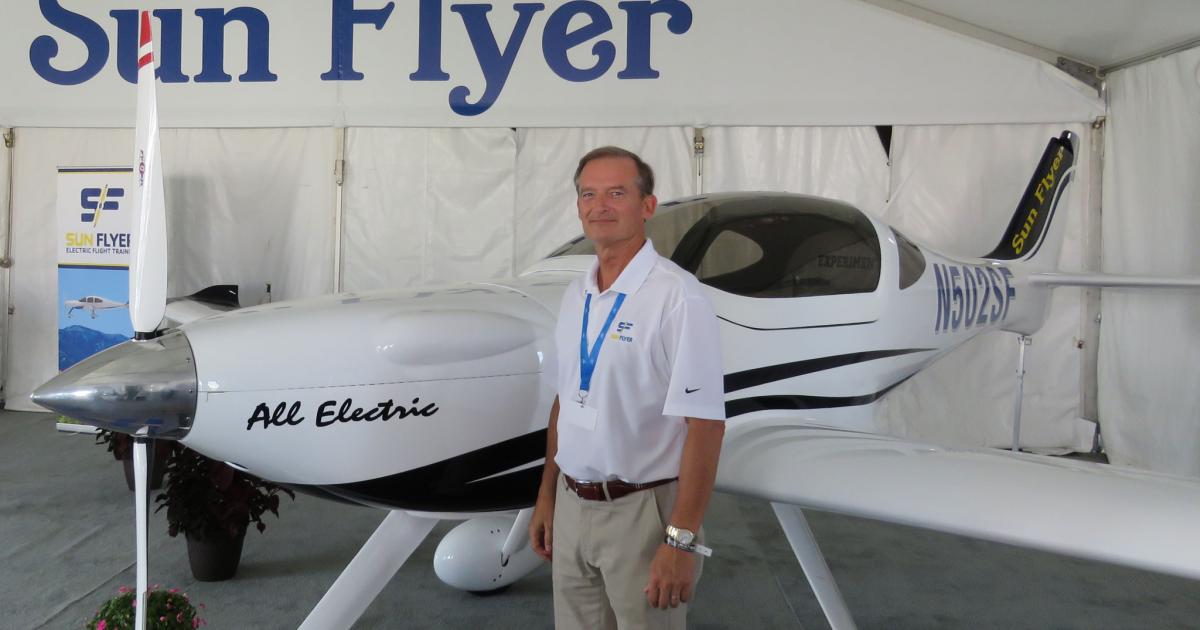 Aerospace entrepreneur George Bye stands next to a prototype of his Sun Flyer two-seat all-electric trainer on display here this week here at AirVenture. Bye claims the $249,000 aircraft will have a three-hour endurance and direct operating costs of $16 per hour. (Photo: Mark Huber)