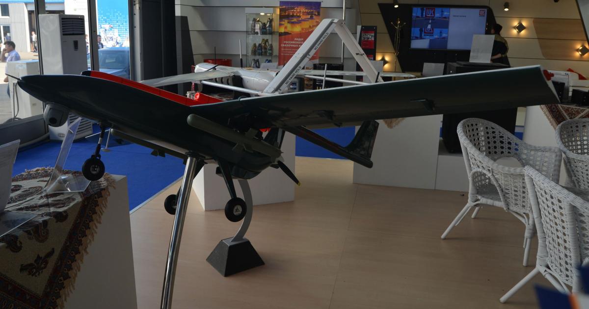 At the MAKS show in Moscow, Iran displayed a scale model of the Mohajer-6 UCAV (foreground), and a full-size Yasir reconnaissance UAV (background). (Photo: Vladimir Karnozov)