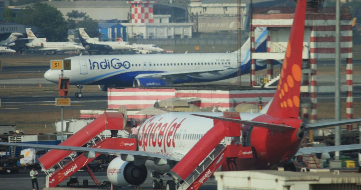 A SpiceJet Boeing 737-800 prepares to accept passengers as an IndiGo Airbus A320 taxis at a busy Mumbai International Airport. (Flickr: <a href="http://creativecommons.org/licenses/by-sa/2.0/" target="_blank">Creative Commons (BY-SA)</a> by <a href="http://flickr.com/people/atom-uk" target="_blank">ATom.UK</a>) 