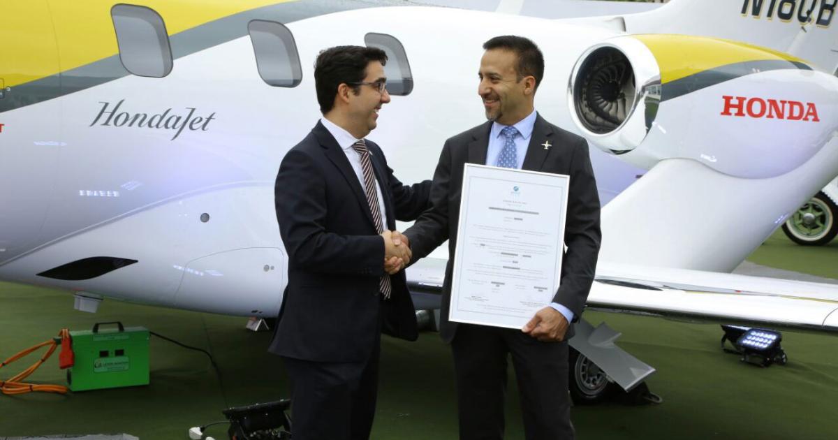 Roberto Honorato, the Superintendent of Department of Airworthiness, National Civil Aviation Agency-Brazil presents the type certificate to Carlos Ayala, manager, certification at Honda Aircraft. (Photo: Honda Aircraft)