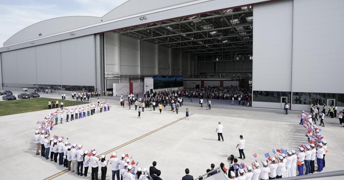 A delegation of industry and government officials prepares to tour a Tianjin Airlines Airbus A330 parked outside the new Tianjin completions and delivery center. (Photo: Airbus)