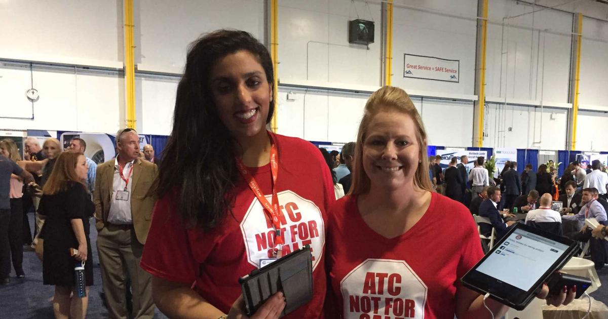 NBAA volunteers Kelley Sandhu and Jessica Oldham roam the NBAA forum halls with iPads to get attendees to instantly contact their congressional representatives to tell them that “ATC is not for sale.” (Photo: Chad Trautvetter)