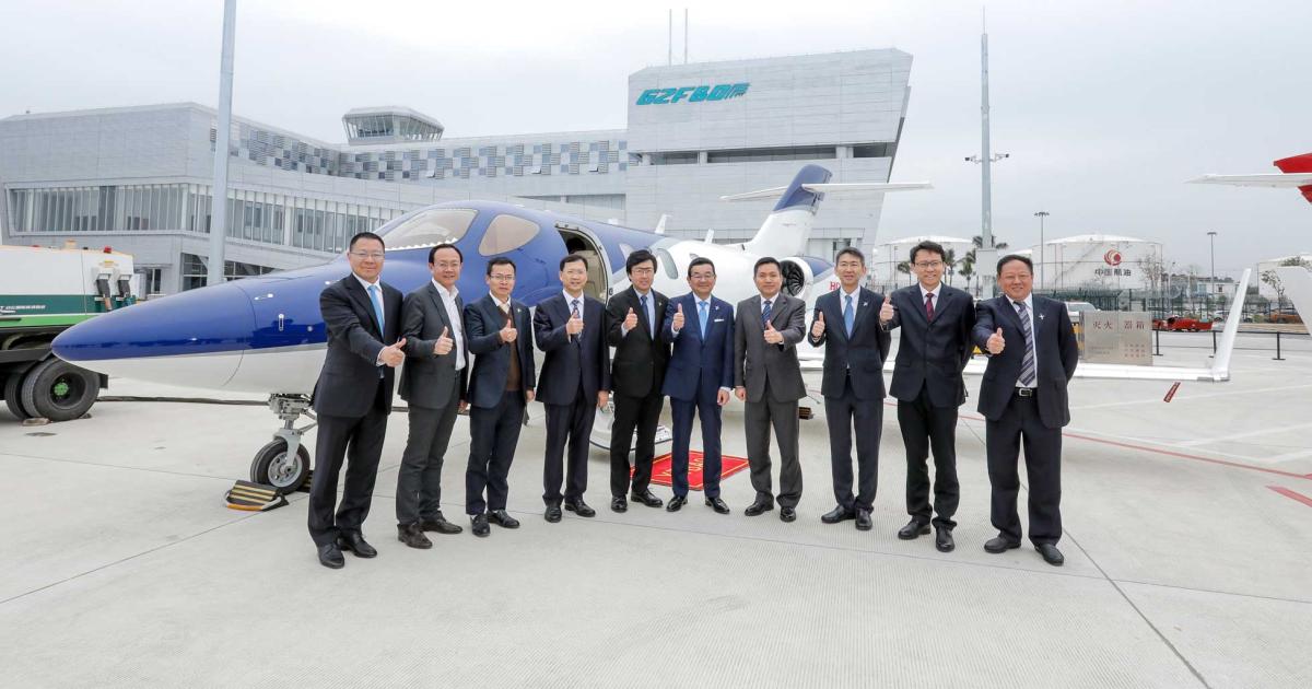 Executives from Honda Motor Company, including president and CEO Takahiro Hachigo and Michimasa Fujino, president and CEO of Honda's aircraft division, celebrate the grand opening of HondaJet China with Honsan General Aviation Company officials in Guangzhou.