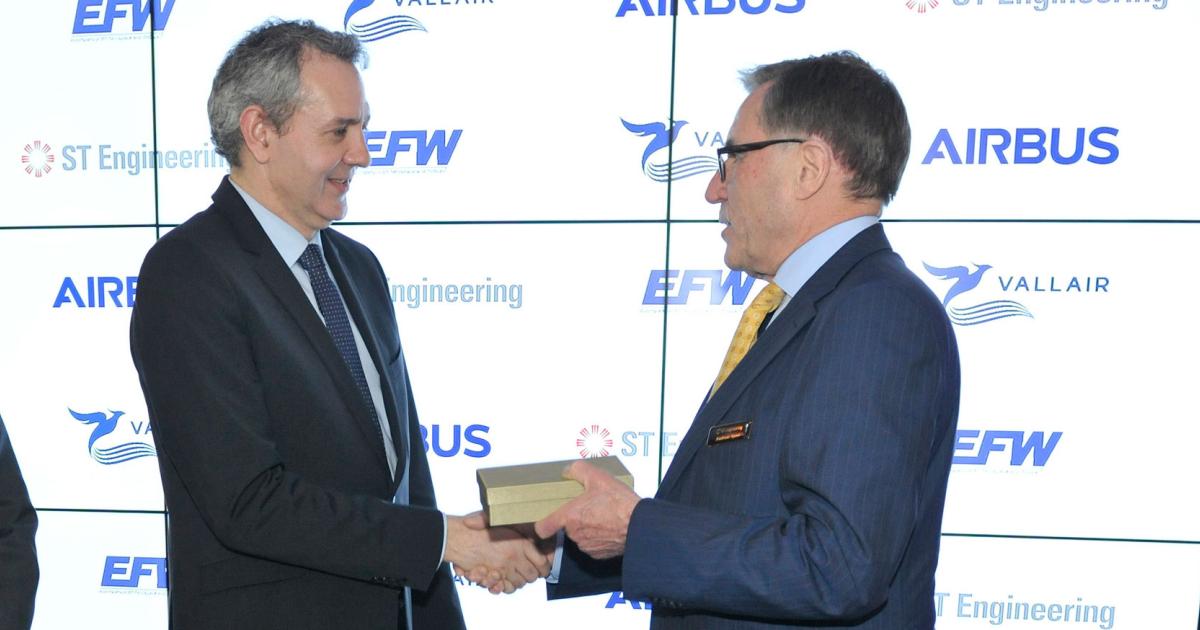 Gregoire Lebigot (left), president and CEO of Vallair, and Dr. Andreas Sperl, president and CEO of EFW, celebrate the launch of the Airbus A321 passenger-to-freighter airliner conversion program at the ST Aerospace stand. Photo: Mark Wagner