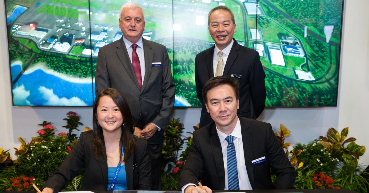 Glory Wee (left), director, aerospace, marine and urban solutions, JTC, and Louis Leong, v-p Hawker Pacific Asia, pause after signing their new MOU. Witnessing the ceremony at the Singapore Airshow 2018 were (left) Alan Smith, CEO, Hawker Pacific, and Ng Lang, CEO, JTC.
