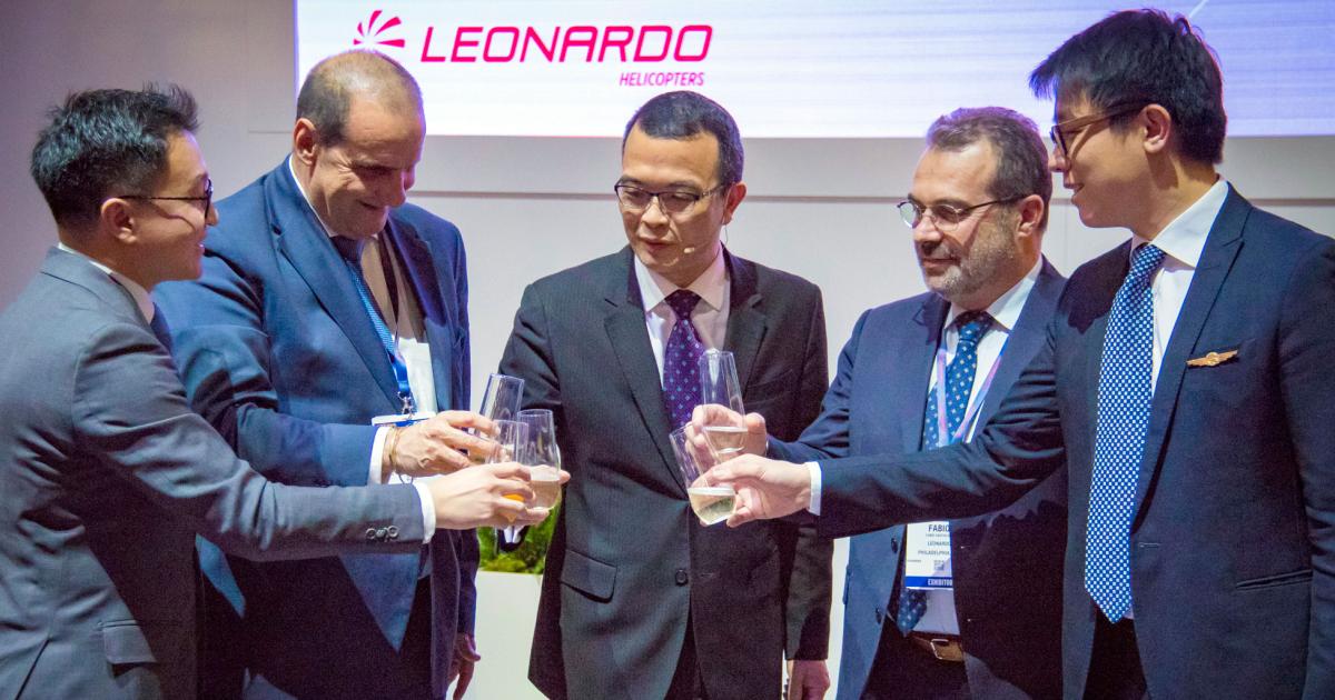 Leonardo Helicopters executives and representatives from Sino-US Intercontinental Helicopter Investment pause Tuesday at Heli-Expo 2018 to toast their agreement for 26 new helicopters.
