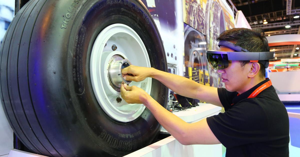 A part of what ST Aerospace calls “Smart MRO” is its augmented reality capabilities, which are being demonstrated at the company’s exhibit to help a technician mount an aircraft wheel. Photo: David McIntosh
