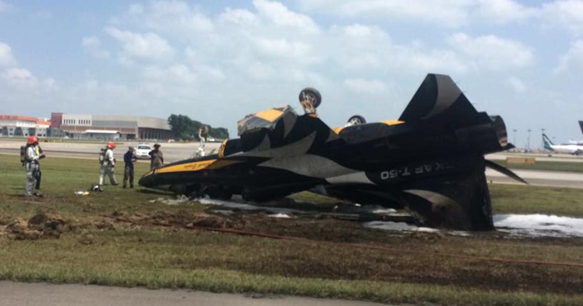 Republic of Korea Air Force (ROKAF) Black Eagles aerobatic team number six T-50B  jet ﻿suffered a burst tire, resulting in a trail of smoke before it flipped over on the grass verge by the runway during an attempted takeoff for a performance at the 2018 Singapore Airshow. The pilot was extricated by airport emergency services and suffered minor injuries, according to reports. (Photo: Local Singapore Newspapers)