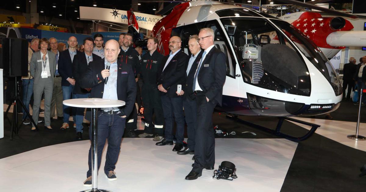 Richard Simonsen of Norway’s Helitrans AS addresses the crowd at Kopter’s booth Tuesday on the Heli-Expo 2018 exhibit floor. Helitrans accounts for more than half of the 23 firm orders for Kopter’s forthcoming SH09.