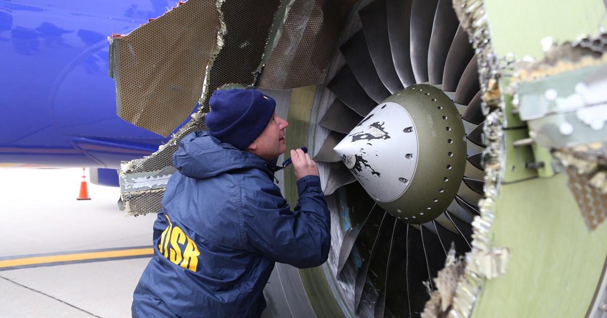 A member of the NTSB go team investigating the uncontained failure of a CFM56-7B turbofan on a Southwest Airlines 737-700 examines fan blade damage on the engine in question. (Photo: NTSB)