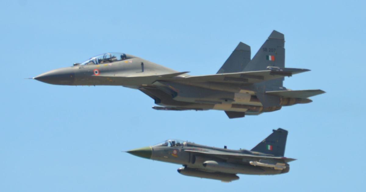 The opening flypast at DefExpo included an indigenous HAL Tejas jet (background), accompanying an Indian air force Su-30MKI fighter. (Photo: Vladimir Karnozov)