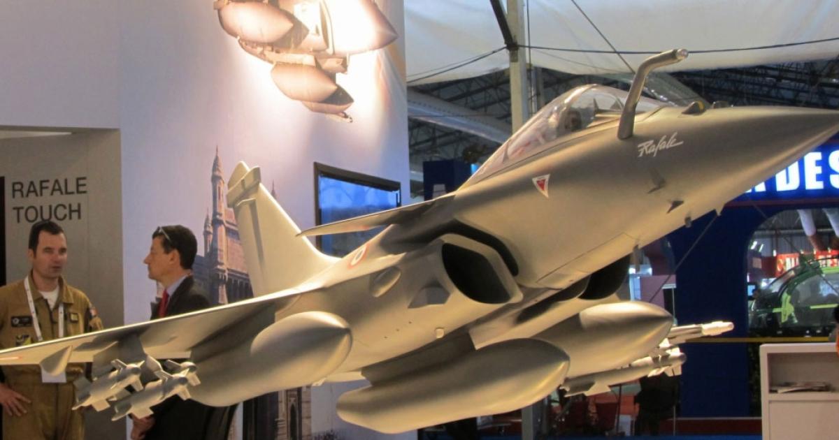 A model of a Rafale in Indian colors displayed on the Dassault stand at an Aero India show. (Photo: Neelam Mathews)