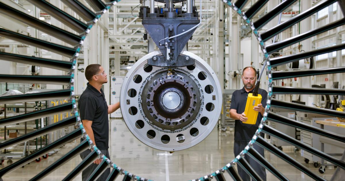 Mechanics examine a PW1100G engine at UTC's Pratt & Whitney engine center in West Palm Beach, Florida. (Photo: Pratt & Whitney)