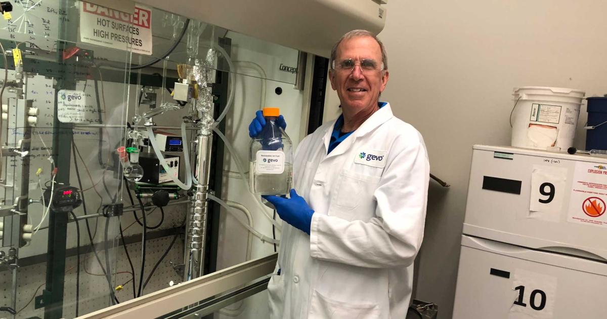 Dr. Jonathan Smith, biofuel producer Gevo's director of chemical technology, shows off a flask of his company's renewable jet fuel at the company's Denver headquarters. Gevo plans to begin construction on a larger scale refinery, which will help fulfill its recently announced offtake agreement with Avfuel.