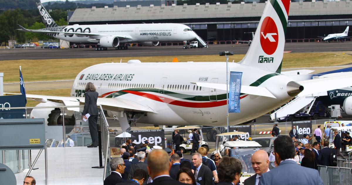A Bangladesh Airlines Boeing 787 (foreground) sits parked on static display while an Airbus A350-1000 prepares to taxi at the Farnborough Airshow. (Photo: David McIntosh)