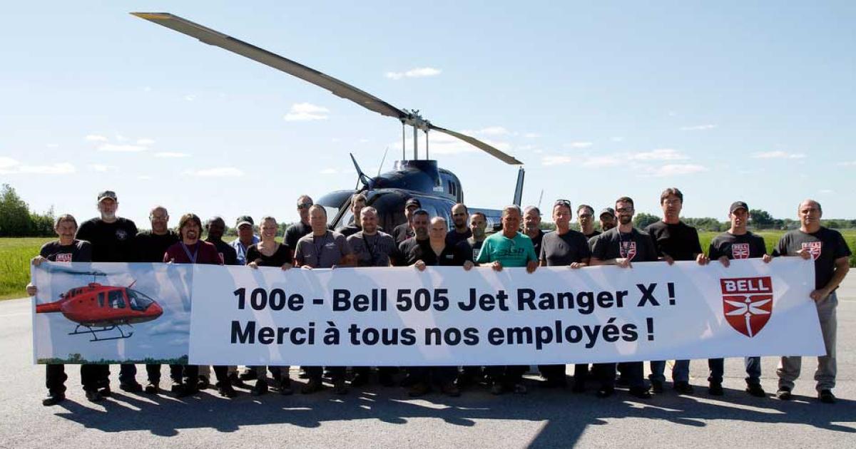 Bell employees at the helicopter maker's Montreal-area facility pose for a celebratory photo with the 100th 505 to roll off the assembly line. Worldwide, Bell holds letters of intent for more than 400 of the light single-engine rotorcraft.